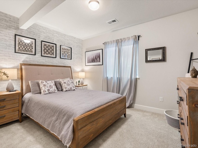 bedroom with light colored carpet, brick wall, visible vents, baseboards, and beamed ceiling