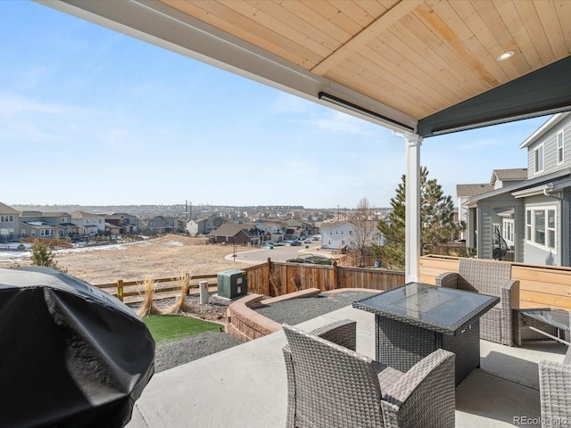 view of patio / terrace featuring outdoor dining space, grilling area, fence, and a residential view