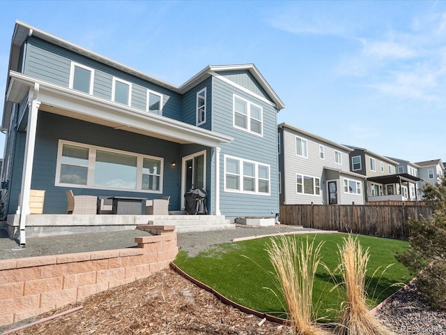 view of front of property with a front lawn and fence