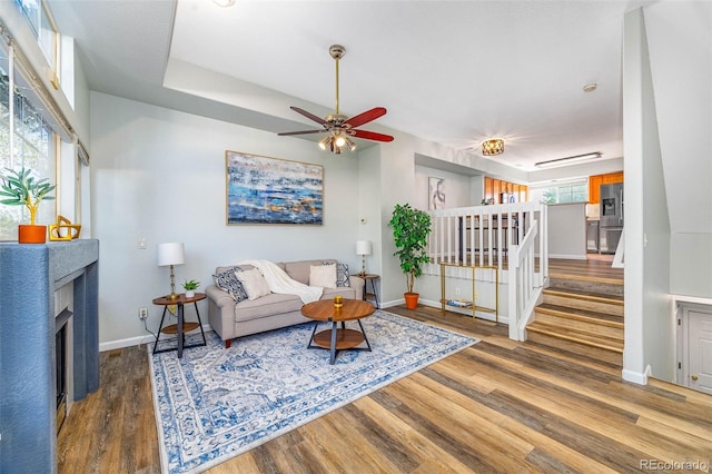 8199 Welby Rd Unit 4106, Denver, CO 80229 - living room featuring wood finished floors, stairway, and plenty of natural light