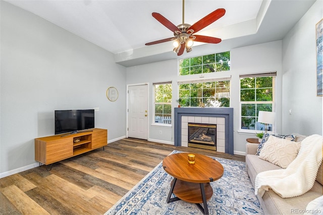 8199 Welby Rd Unit 4106, Denver, CO 80229 - living room with a fireplace, wood finished floors, and a ceiling fan