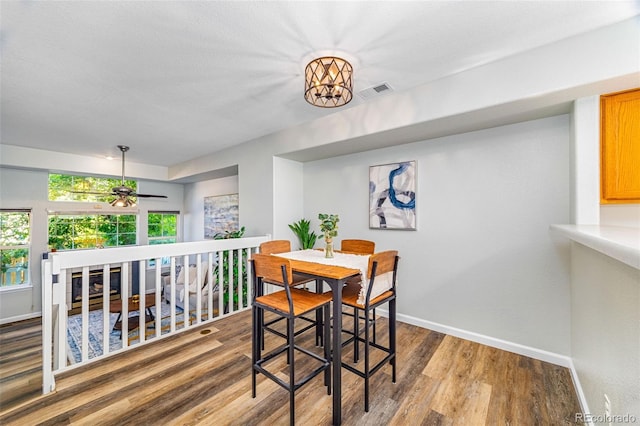 8199 Welby Rd Unit 4106, Denver, CO 80229 - dining room featuring baseboards and wood finished floors