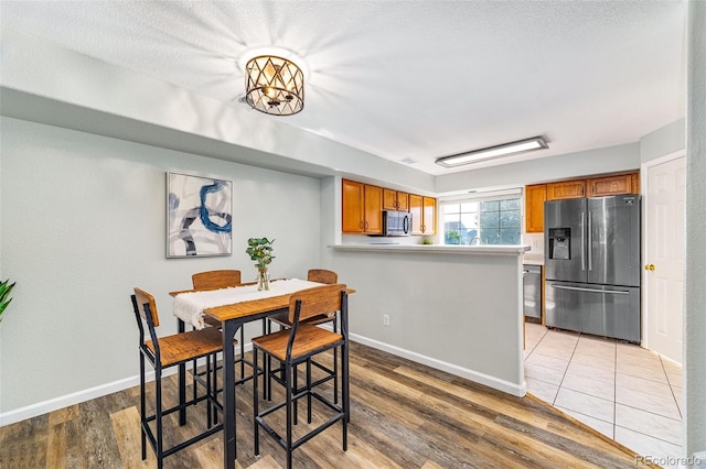 8199 Welby Rd Unit 4106, Denver, CO 80229 - dining space with light wood-style flooring and baseboards