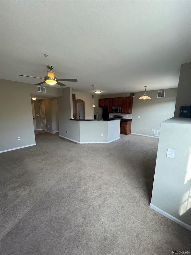 unfurnished living room featuring carpet and ceiling fan