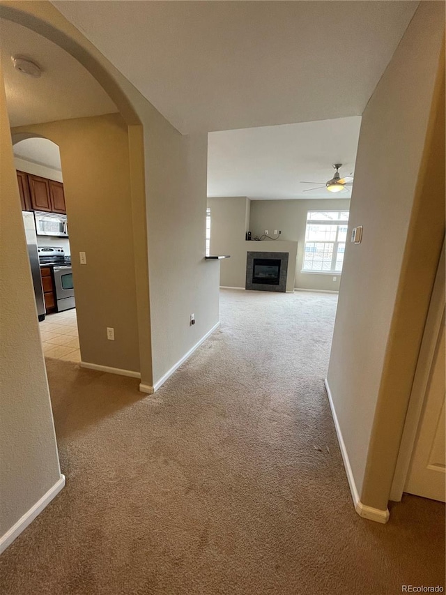 corridor featuring light colored carpet