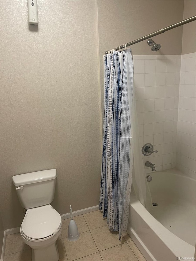 bathroom featuring toilet, tile patterned floors, and shower / bath combo