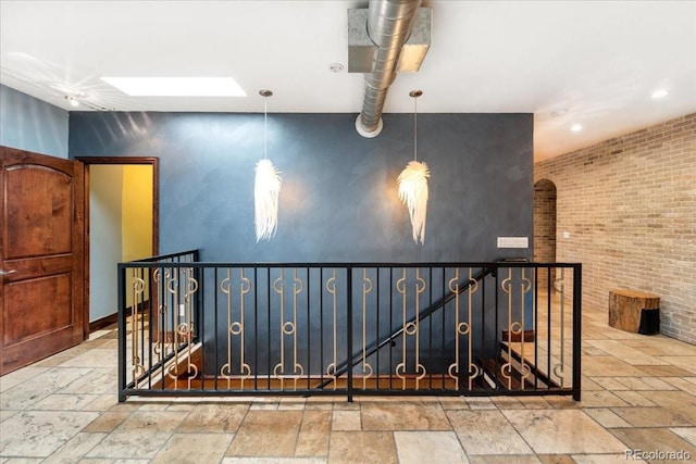 2150 Curtis St, Denver, CO 80205 - stairway with stone tile floors, an accent wall, a skylight, and recessed lighting