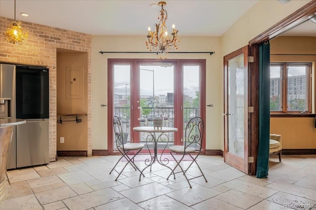 2150 Curtis St, Denver, CO 80205 - dining room with stone tile floors, baseboards, french doors, and a chandelier