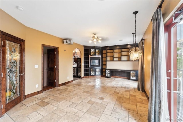 2150 Curtis St, Denver, CO 80205 - unfurnished living room with stone tile flooring, baseboards, built in features, and ceiling fan
