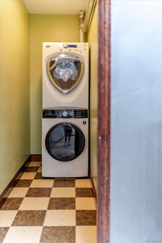 2150 Curtis St, Denver, CO 80205 - laundry room featuring estacked washer and dryer and tile patterned floors