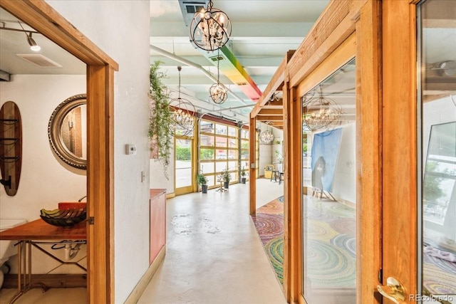 2150 Curtis St, Denver, CO 80205 - hall featuring a chandelier and finished concrete flooring