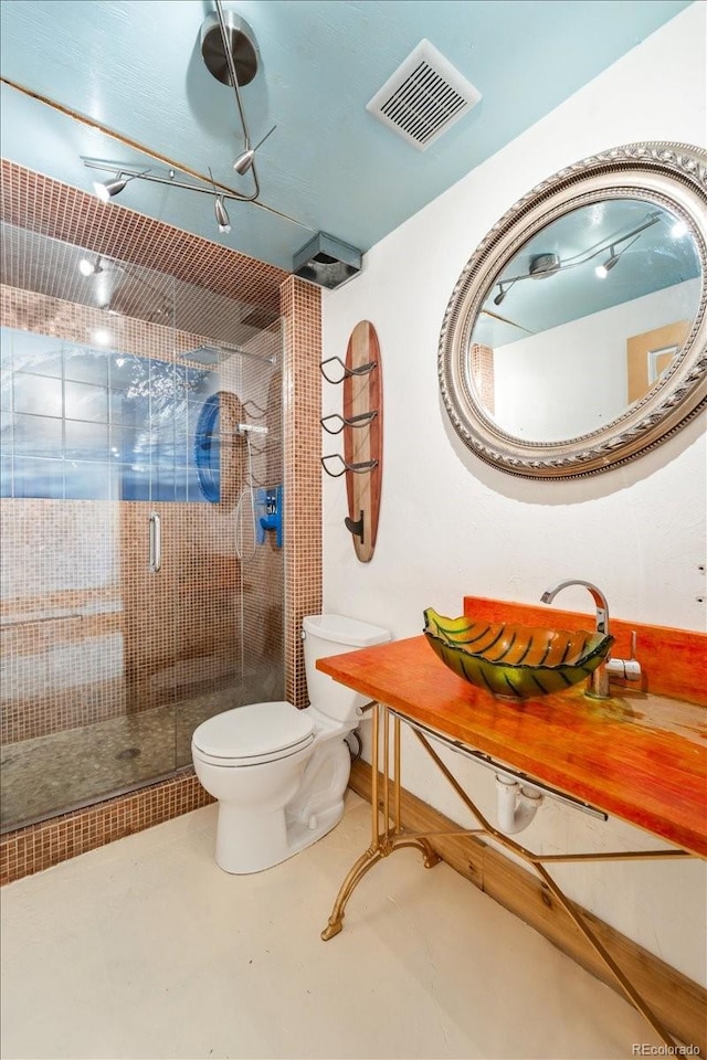 2150 Curtis St, Denver, CO 80205 - bathroom with toilet, a shower stall, concrete flooring, and vanity