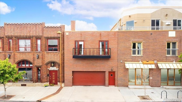 2150 Curtis St, Denver, CO 80205 - view of building exterior featuring an attached garage and driveway