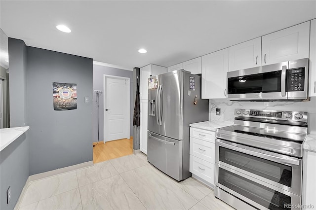 14300 E Marina Dr Unit 109, Aurora, CO 80014 - kitchen with appliances with stainless steel finishes, white cabinets, light stone counters, ornamental molding, and recessed lighting