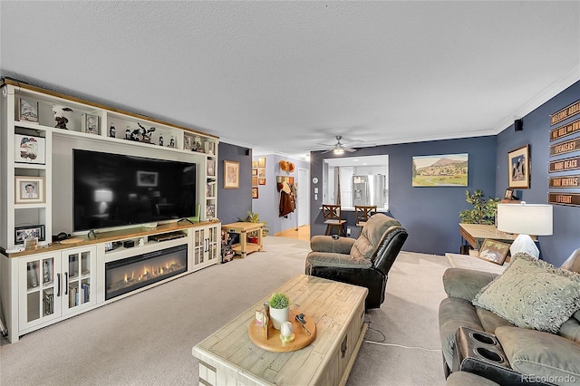 14300 E Marina Dr Unit 109, Aurora, CO 80014 - living area featuring ceiling fan, carpet, crown molding, a glass covered fireplace, and a textured ceiling