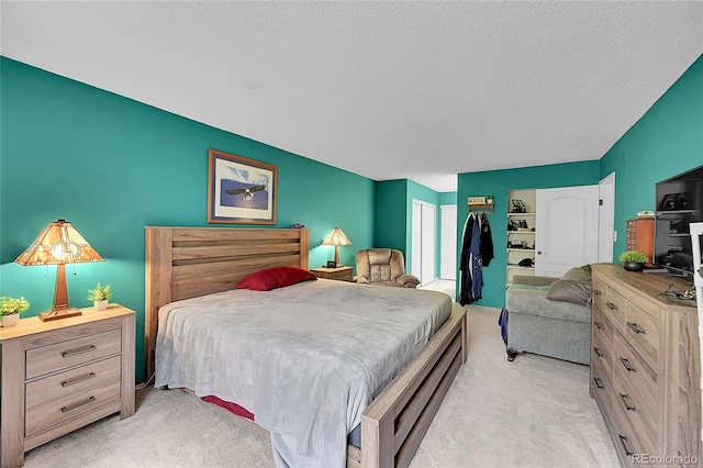 14300 E Marina Dr Unit 109, Aurora, CO 80014 - bedroom with light colored carpet, a textured ceiling, and a closet
