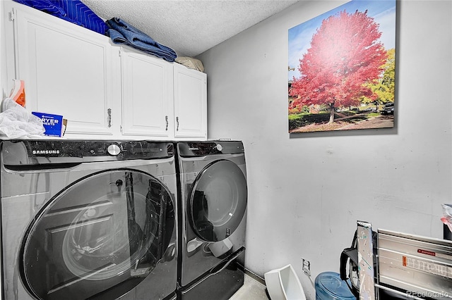 14300 E Marina Dr Unit 109, Aurora, CO 80014 - laundry room with cabinet space, washer and clothes dryer, and a textured ceiling