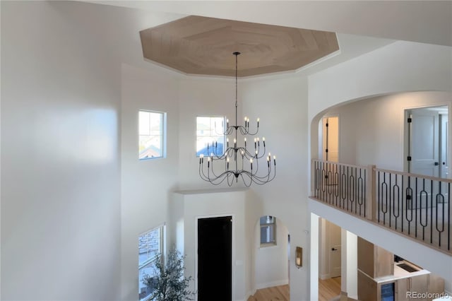 room details featuring a tray ceiling and a notable chandelier