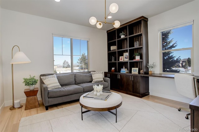 living room featuring light hardwood / wood-style flooring and a notable chandelier