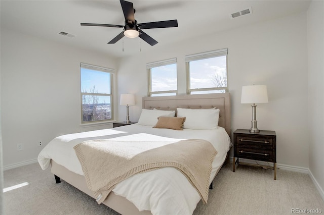 bedroom featuring light colored carpet and ceiling fan