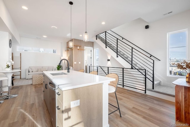 2920 W Parkside Pl, Denver, CO 80221 - kitchen featuring dishwasher, light wood finished floors, a sink, a center island with sink, and open floor plan