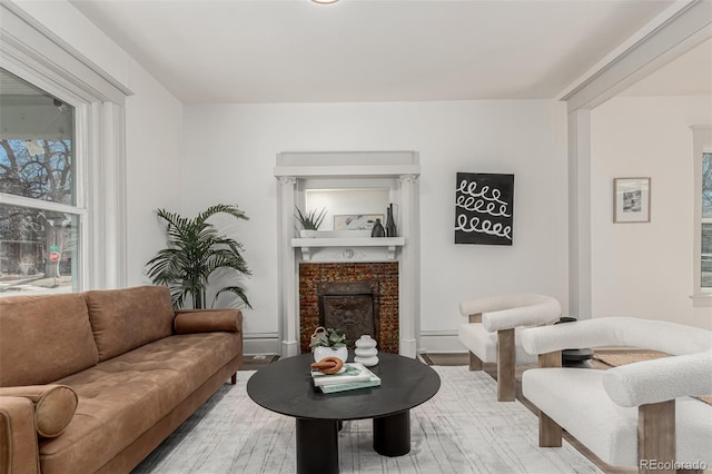 living room with a fireplace and wood finished floors