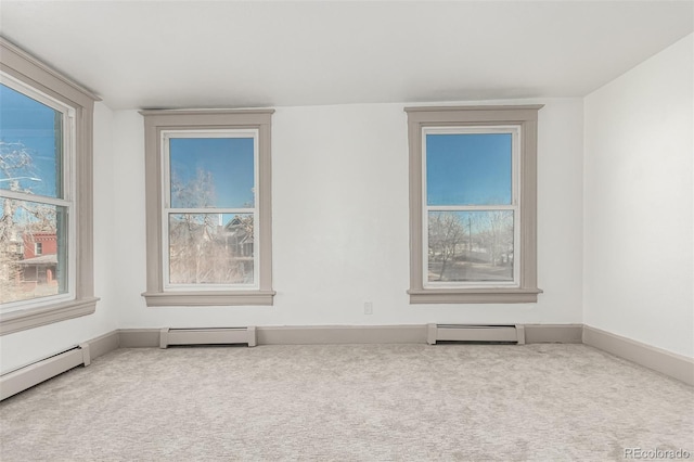 carpeted spare room with a baseboard radiator and baseboard heating