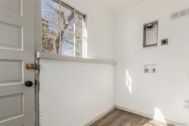 washroom with hookup for a washing machine, visible vents, electric dryer hookup, wood finished floors, and laundry area