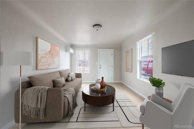 living room featuring light hardwood / wood-style flooring and an AC wall unit