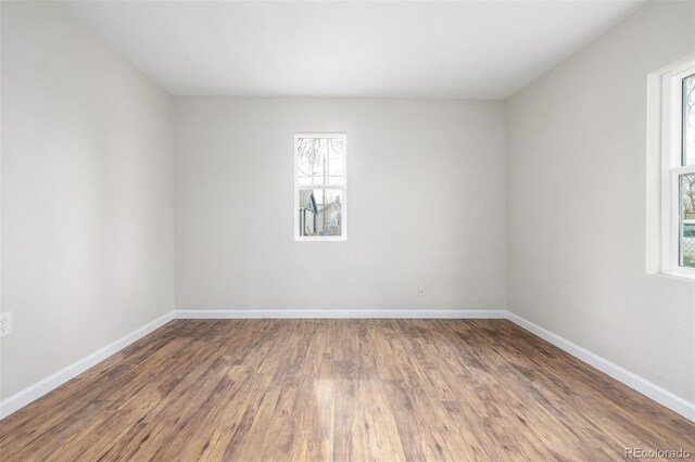 spare room with hardwood / wood-style floors