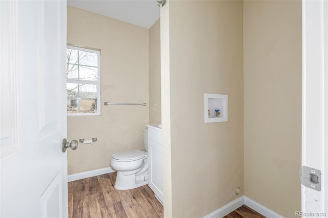 bathroom featuring hardwood / wood-style flooring, vanity, and toilet