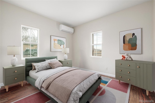 bedroom featuring dark hardwood / wood-style floors and an AC wall unit