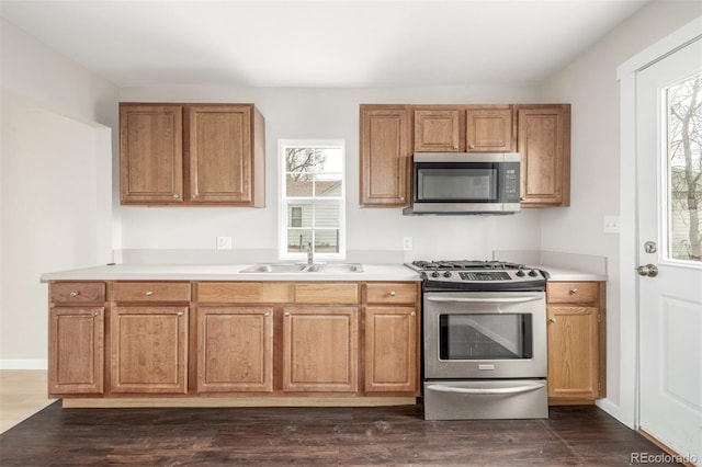 kitchen featuring dark wood-type flooring, appliances with stainless steel finishes, sink, and plenty of natural light