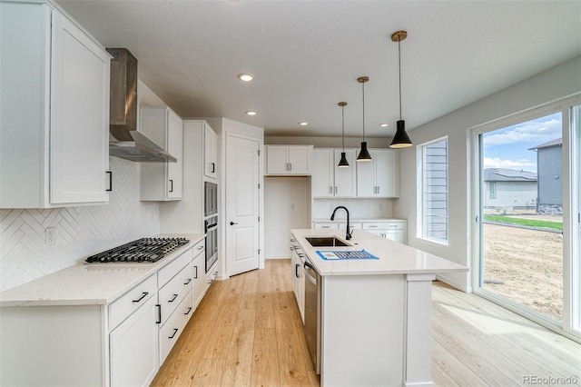 23708 E 42nd Ave, Aurora, CO 80019 - kitchen with wall chimney exhaust hood, a sink, appliances with stainless steel finishes, light wood-style floors, and recessed lighting