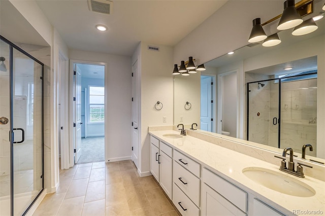 23708 E 42nd Ave, Aurora, CO 80019 - bathroom featuring a shower stall, tile patterned floors, double vanity, baseboards, and toilet
