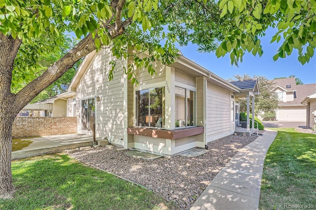view of side of property with a patio area