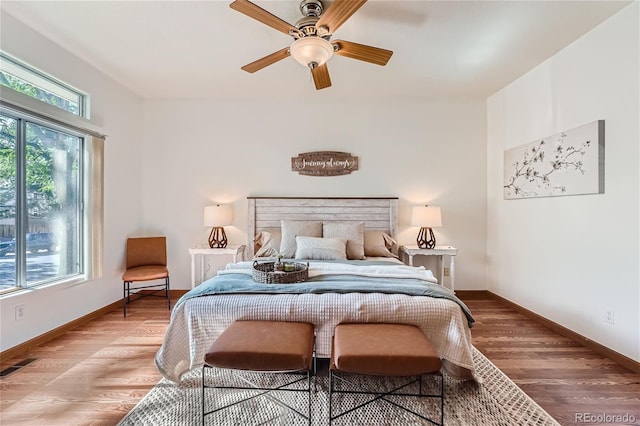 bedroom featuring light wood-type flooring, baseboards, and ceiling fan