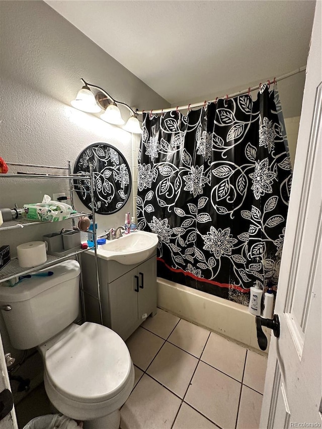 bathroom with tile patterned flooring, vanity, curtained shower, and toilet