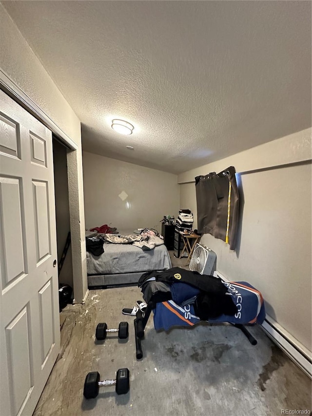 interior space with a baseboard radiator and a textured ceiling