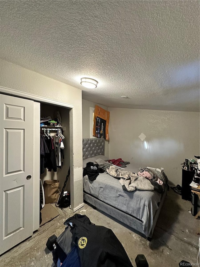 bedroom with a textured ceiling and a closet