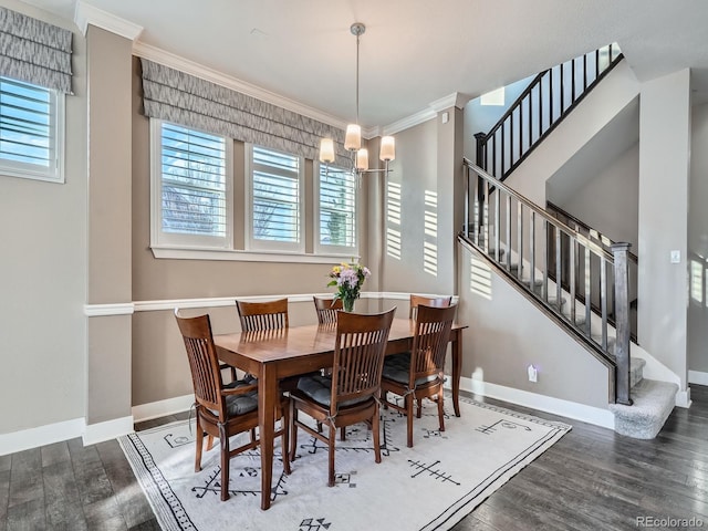 dining space featuring an inviting chandelier, wood finished floors, crown molding, and a healthy amount of sunlight