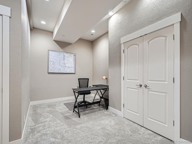 carpeted office with recessed lighting, baseboards, and a textured wall