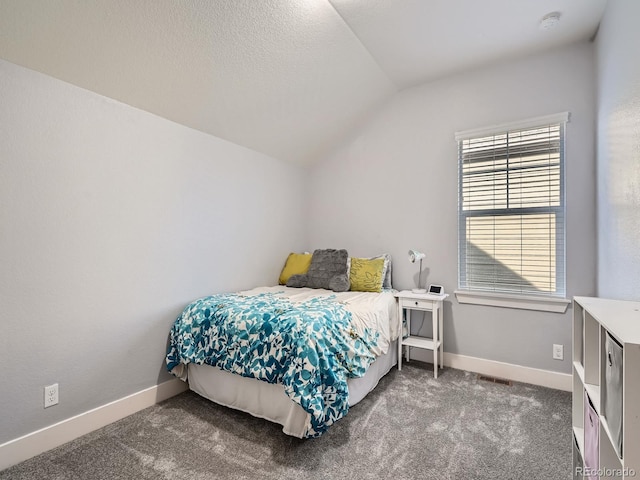 carpeted bedroom with lofted ceiling, baseboards, and a textured ceiling