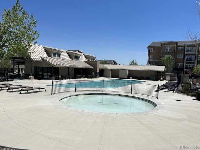 community pool featuring a patio area and fence