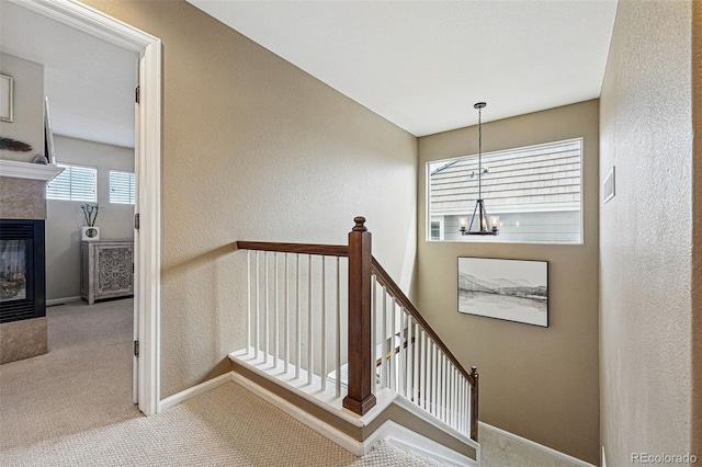 12996 Banyon Cir, Parker, CO 80134 - stairs featuring a chandelier, carpet flooring, plenty of natural light, a tiled fireplace, and a textured wall