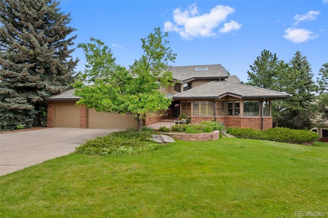 9 Red Fox Ln, Littleton, CO 80127 - view of front of house with concrete driveway, brick siding, a front lawn, and an attached garage