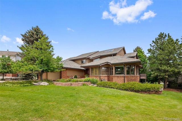 9 Red Fox Ln, Littleton, CO 80127 - view of front facade with a garage, a front lawn, and brick siding