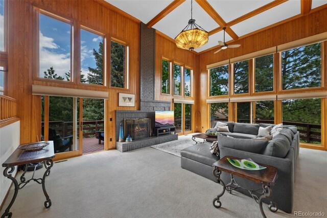 9 Red Fox Ln, Littleton, CO 80127 - living room featuring carpet, wooden walls, a towering ceiling, a brick fireplace, and ceiling fan