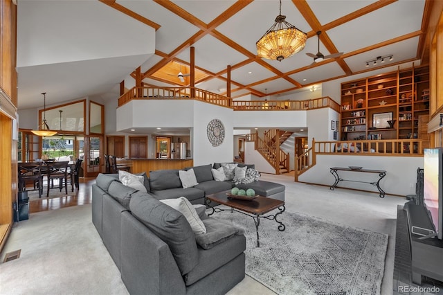 9 Red Fox Ln, Littleton, CO 80127 - carpeted living area with a towering ceiling, stairs, coffered ceiling, recessed lighting, and a chandelier