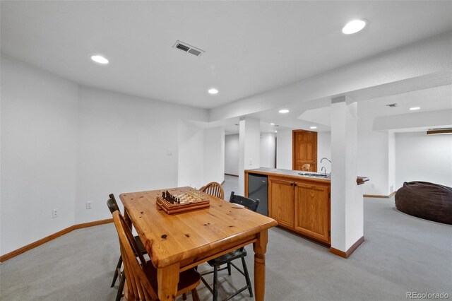 9 Red Fox Ln, Littleton, CO 80127 - dining area featuring light colored carpet, bar with sink, recessed lighting, and baseboards